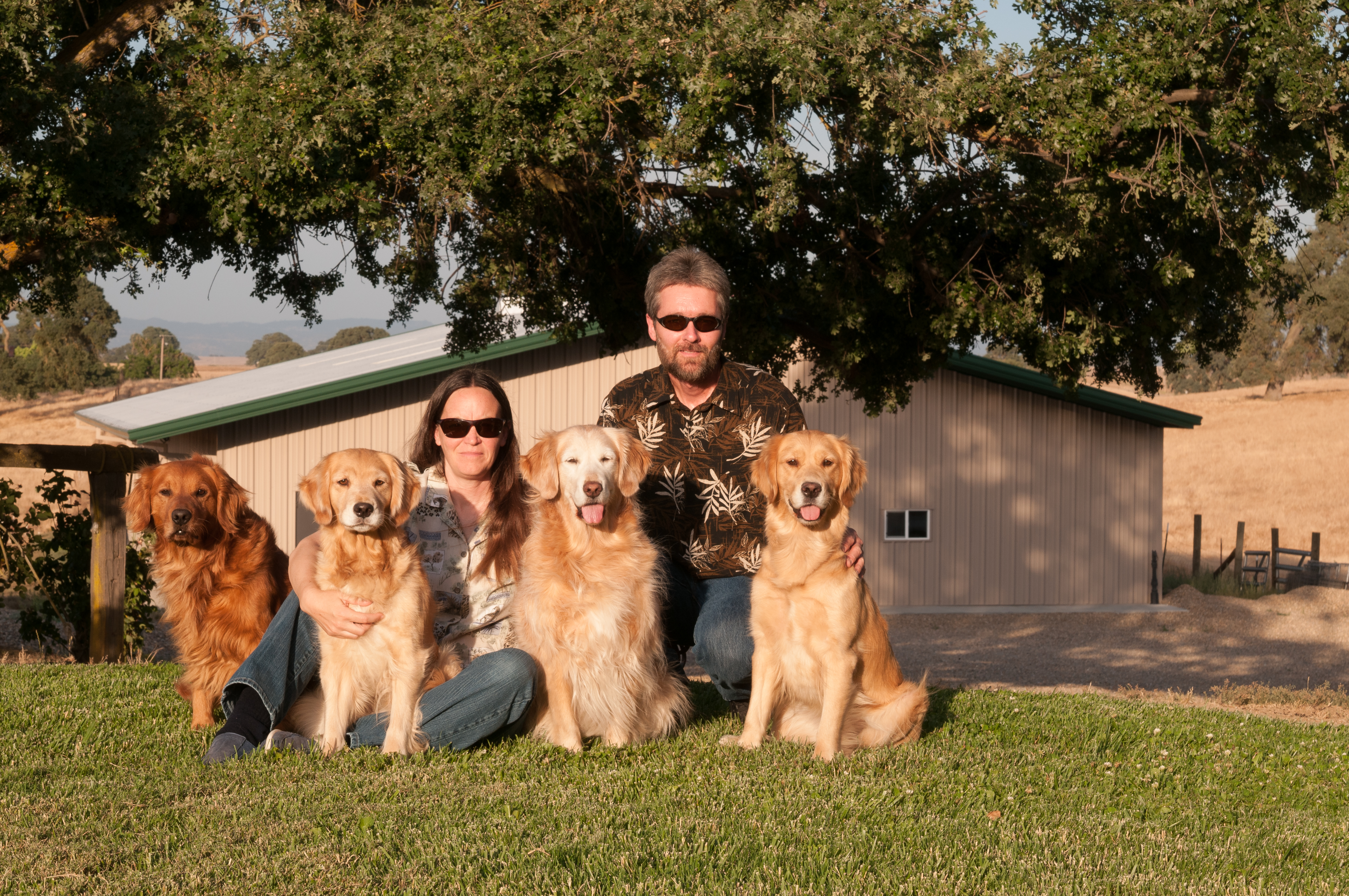 Dee Dee, Bill, and their dogs in front of the Dream Big Training Center.